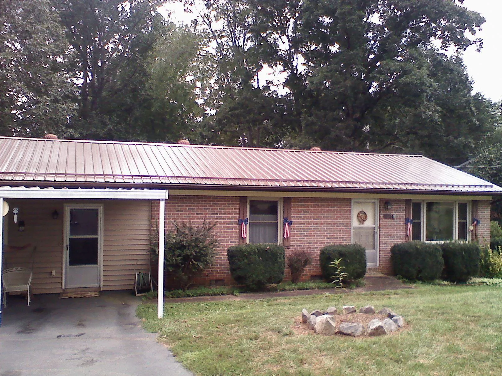 Bronze metal roof and carport on a brick ranch home — Roof Repair work by our crew in Burnside